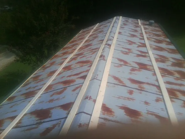 Rusted metal roof panels with new wood purlins before replacement — Storm Damage Roof Repair in Highmount by Roofing Brothers